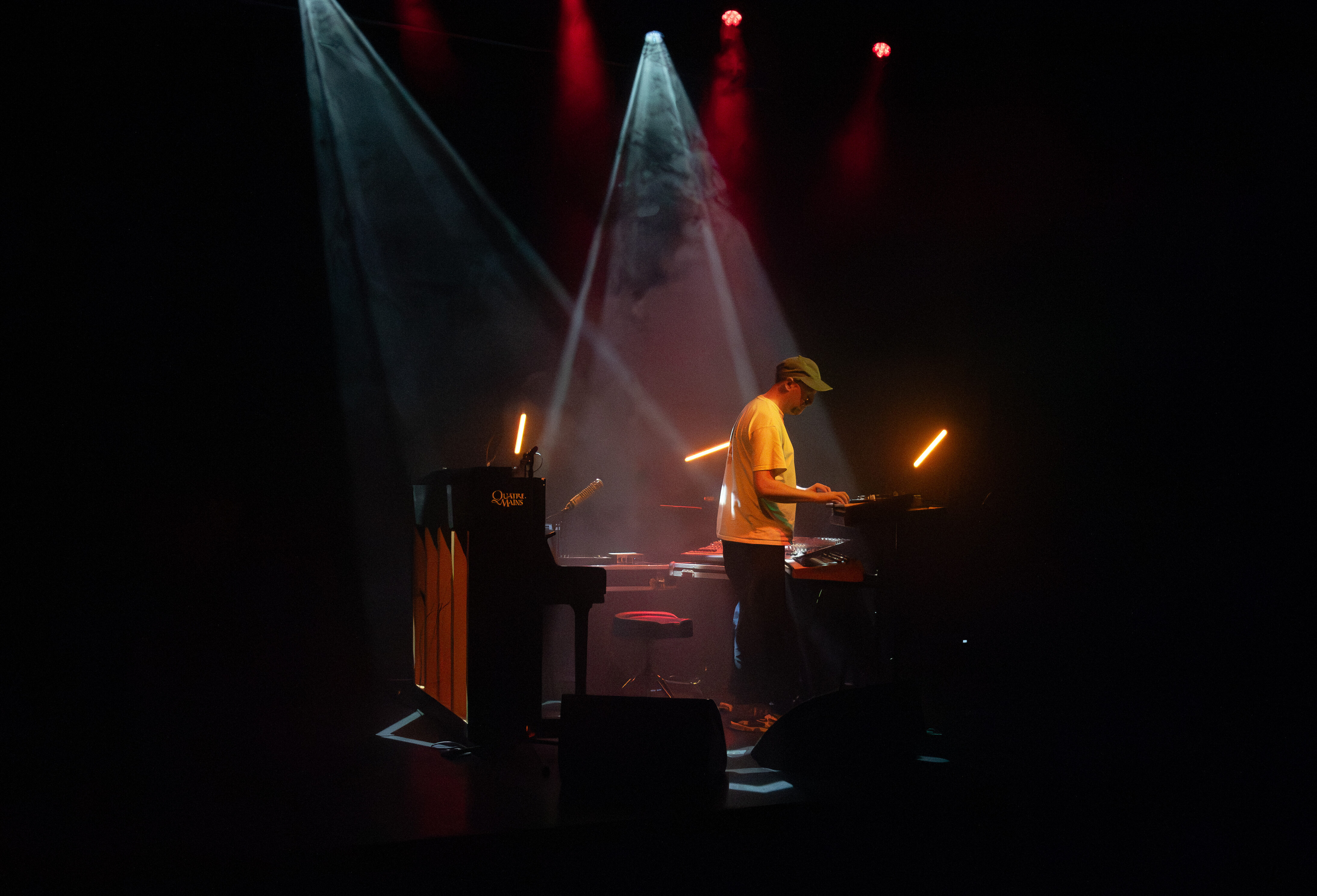 SOHN is testing out his music instruments before the show. 