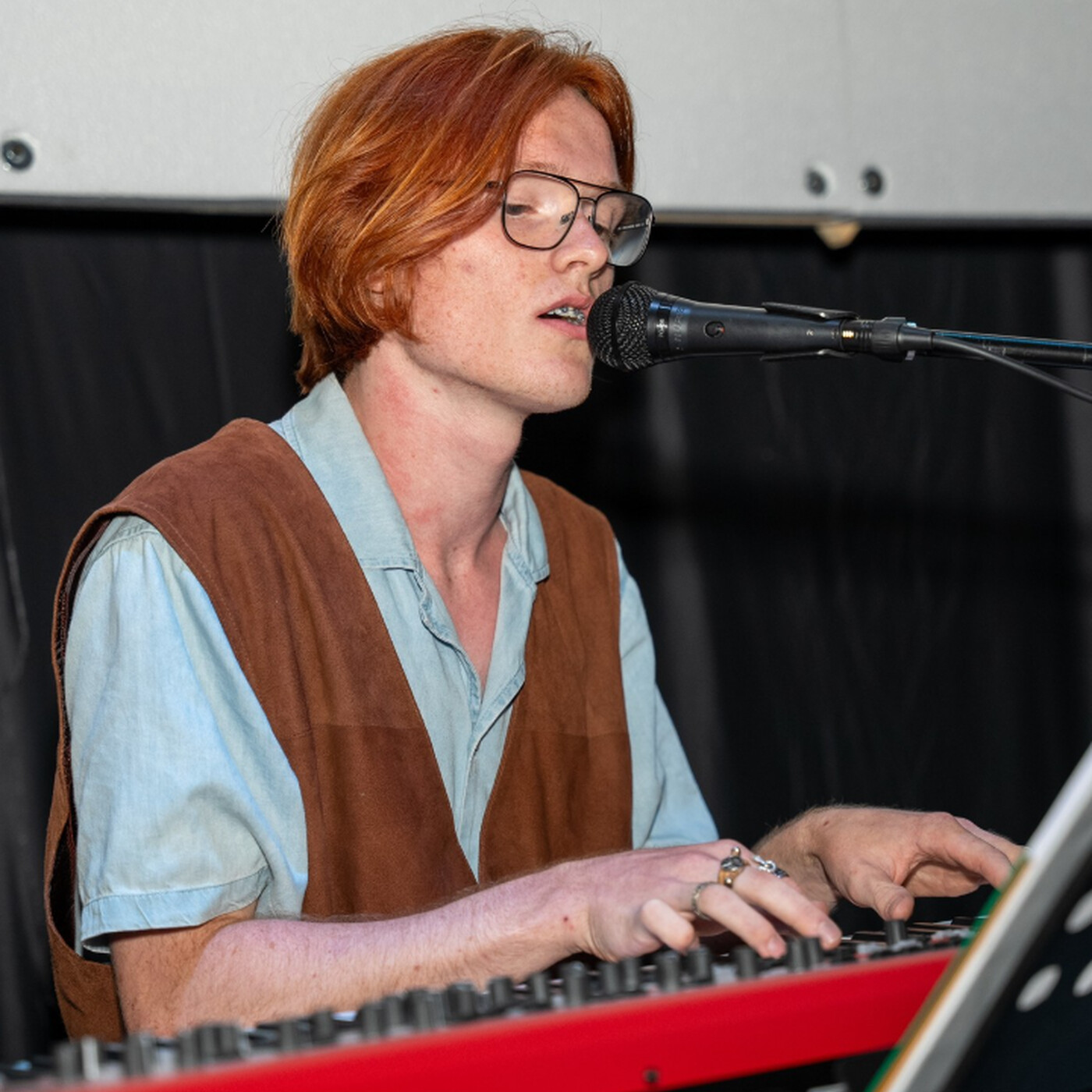 Young musician who plays in a band and records music.